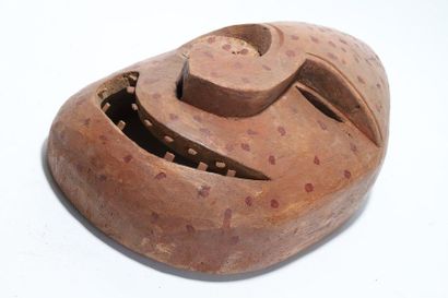 Decorative mask with a deformed face 
 
Wood,...