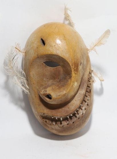 Decorative anthropomorphic mask with a deformed...