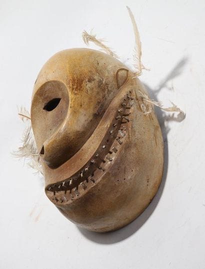 Decorative anthropomorphic mask with a deformed...