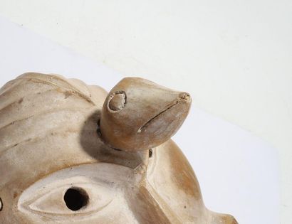 Decorative mask with a deformed face 
 
Wood,...