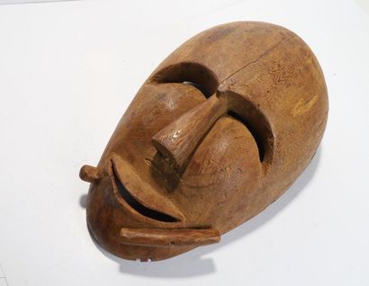 Anthropomorphic decorative mask with a smiling...