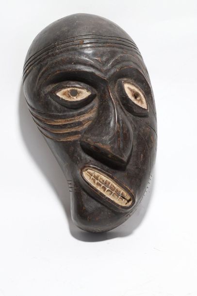 Decorative mask with a deformed face 
 
Wood...