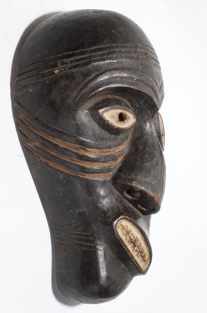 Decorative mask with a deformed face 
 
Wood...