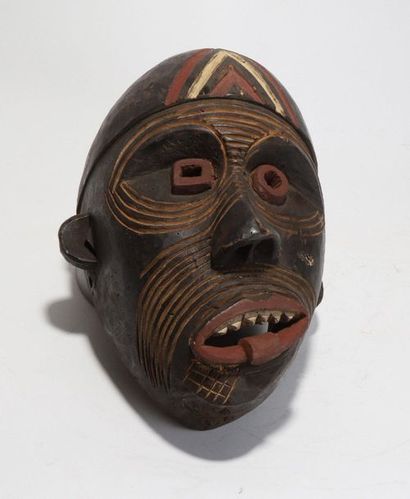 Decorative mask with a deformed face 
 
Wood...