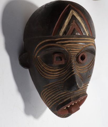 Decorative mask with a deformed face 
 
Wood...