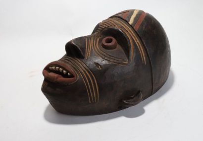 Decorative mask with a deformed face 
 
Wood...