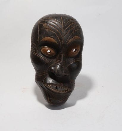 Decorative mask with a deformed face 
 
Wood...