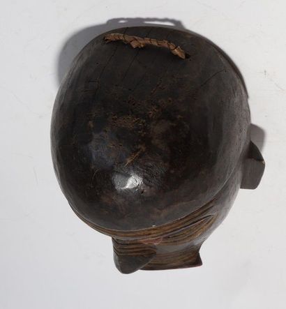 Decorative mask with a deformed face 
 
Wood...