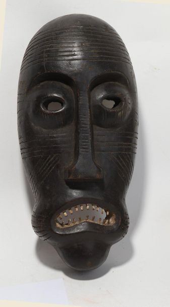 Decorative mask with a deformed face 

Wood...