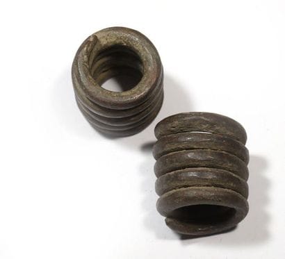 Two wrought iron slave bracelets or coins...
