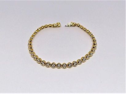 BRACELET rivière en or jaune 18K (750/°°),...