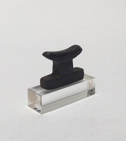 Hematite amulet representing a bedside table.

Egypt,...
