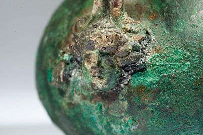 Bronze vase with green patina, the handle...