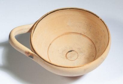 Beige terracotta tase with one handle painted...