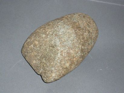 Polished axe. Grey stone with earthy deposit....