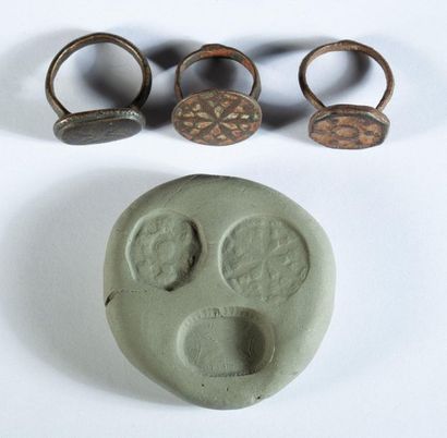 Three bronze rings decorated with rosettes...