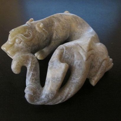 Jade tiger turning around. Patinated celadon...