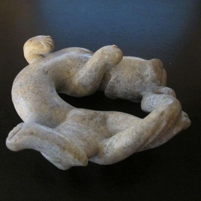 Jade tiger turning around. Patinated celadon...
