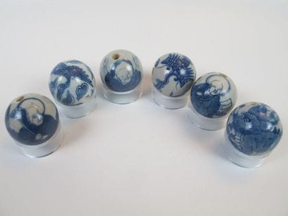 Six white-blue enameled porcelain beads....