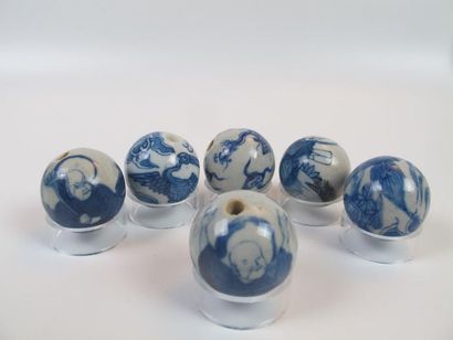 Six white-blue enameled porcelain beads....
