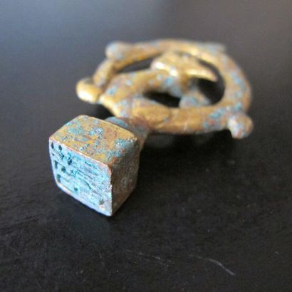 Small square stamp, the catch formed by a...