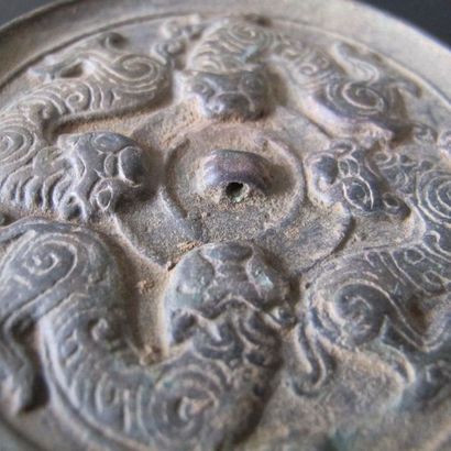 Mirror with four tigers biting the disc of...
