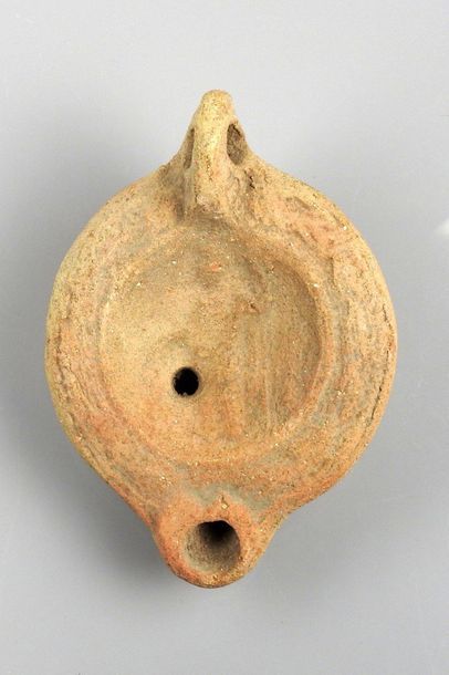 Cordiform oil lamp with decoration of a deity...