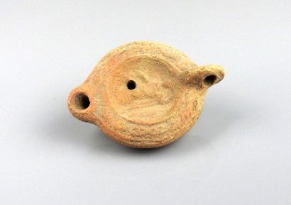 Cordiform oil lamp with decoration of a deity...