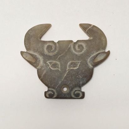 Very stylized brown/yellow jade bovid's head....