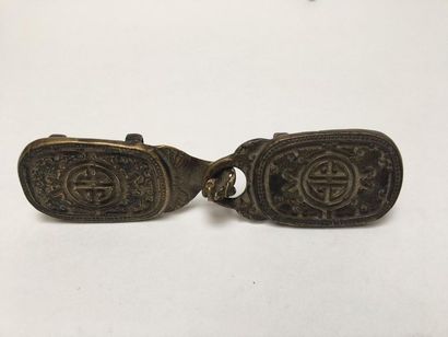 Bronze belt buckle decorated with monograms...