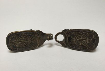 Bronze belt buckle decorated with monograms...