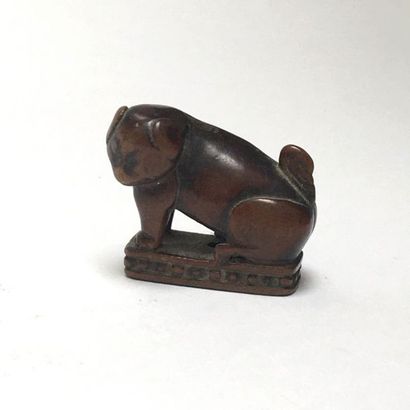 Dog (Sharpeï) made of huanyang wood sitting...