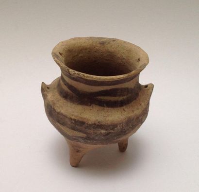 Beige terracotta tripod vase decorated with...