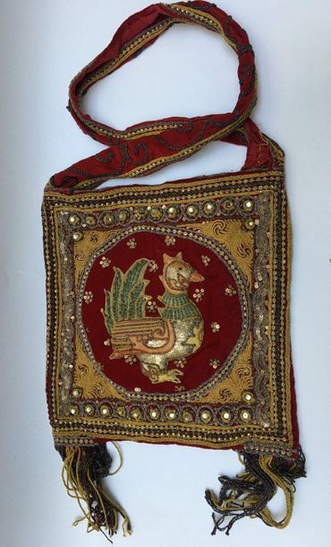 Shoulder bag embroidered on a red background...