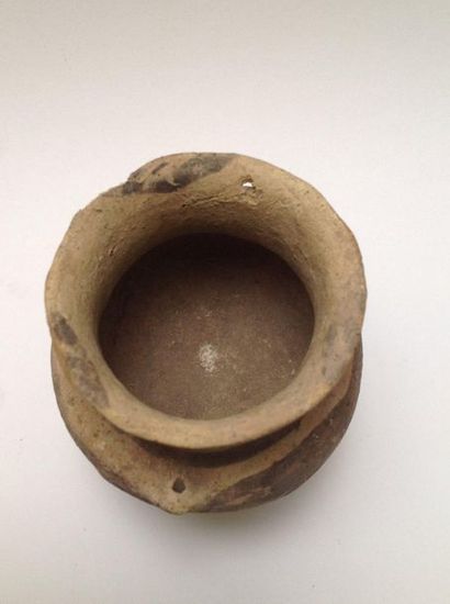 Beige terracotta tripod vase decorated with...