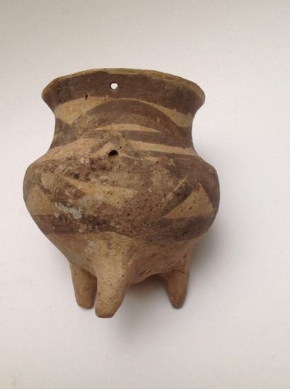 Beige terracotta tripod vase decorated with...
