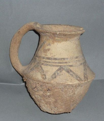 Beige terracotta jug with handle decorated...