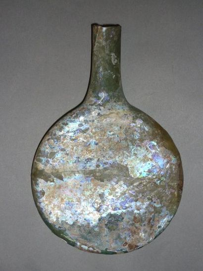 Flat-bellied bottle in well iridescent glass...