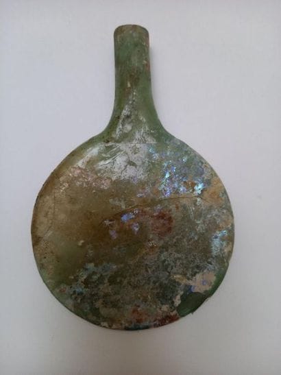 Flat-bellied bottle in well iridescent glass...