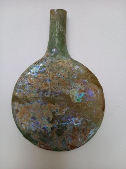 Flat-bellied bottle in well iridescent glass...