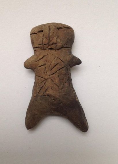 Pink terracotta figurine representing a stylized...