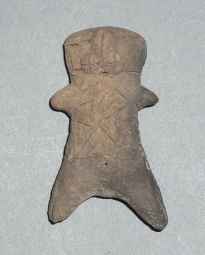 Pink terracotta figurine representing a stylized...
