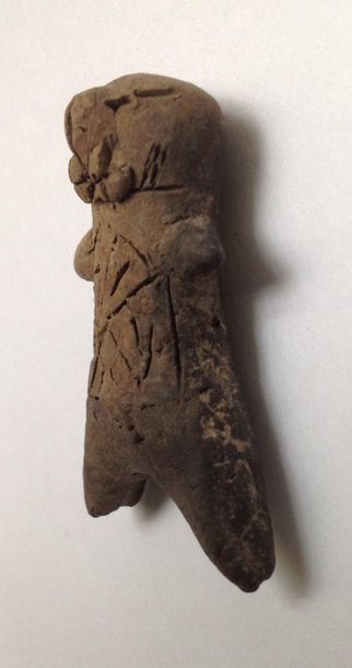 Pink terracotta figurine representing a stylized...