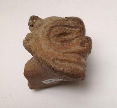 Pink terracotta figurine representing a stylized...
