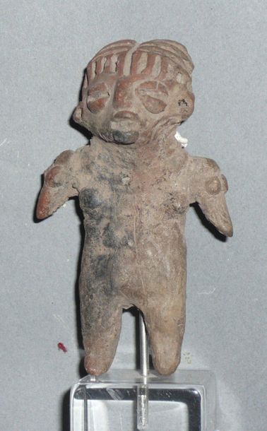 Female figurine standing with her arms spread...