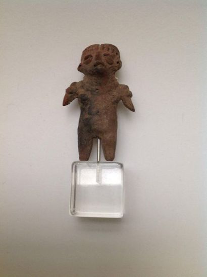 Female figurine standing with her arms spread...