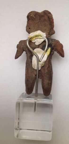 Female figurine standing with her arms spread...