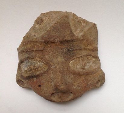 Brown terracotta head with wide open eyes.

Puebla...