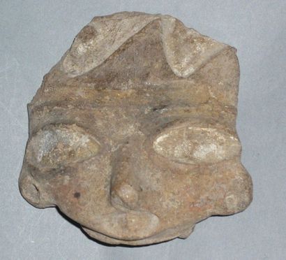Brown terracotta head with wide open eyes.

Puebla...