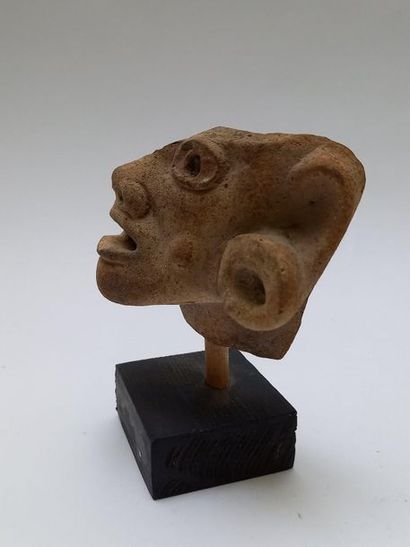Beige terracotta fragmentary head probably...